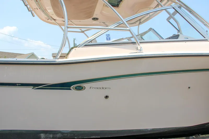 Slide: The Image of 2014 Grady-White Freedom 307 boat side view with sleek design and sturdy frame. - 7