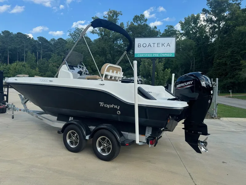 Slide: The Image of 2022 Trophy T20 boat on trailer, certified pre-owned, with Mercury engine, outdoors. - 1