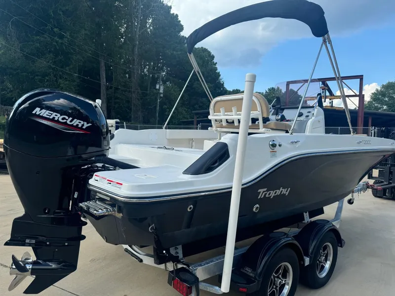 Slide: The Image of 2022 Trophy T20 boat with Mercury engine on trailer, parked outdoors. - 2