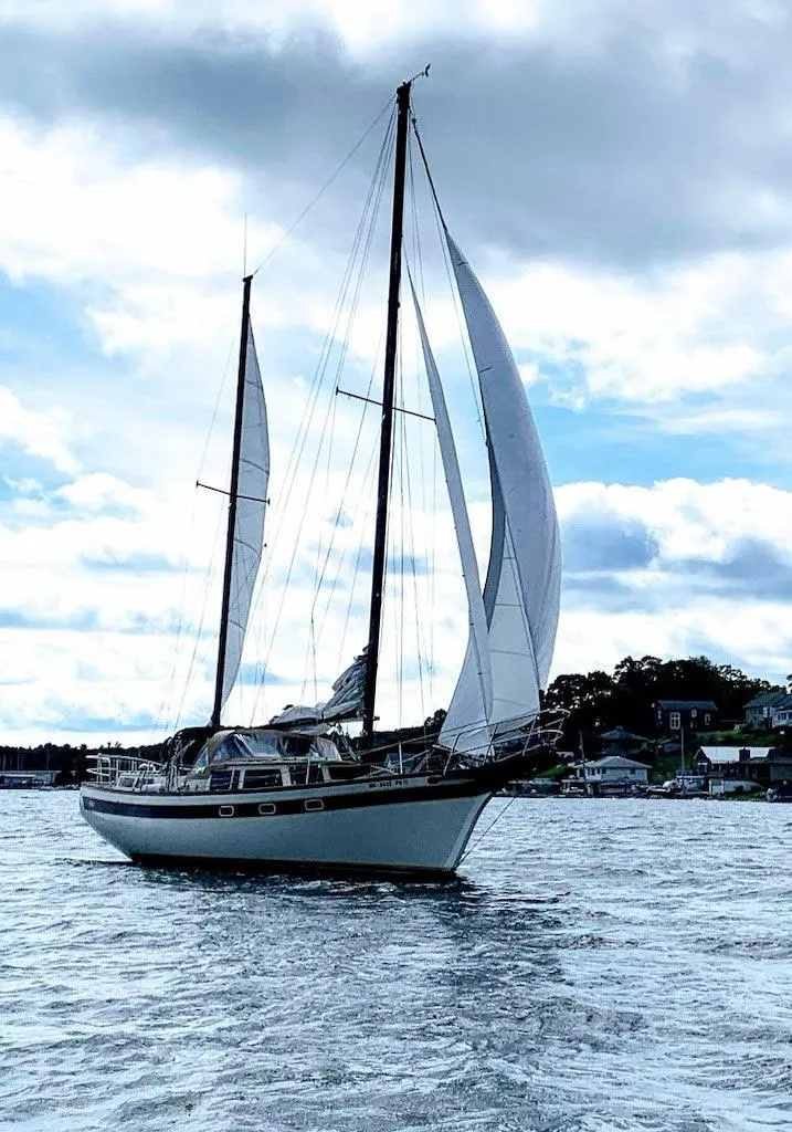 Slide: The Image of 1978 Islander Freeport 41 Ketch sailing on a cloudy day. - 1
