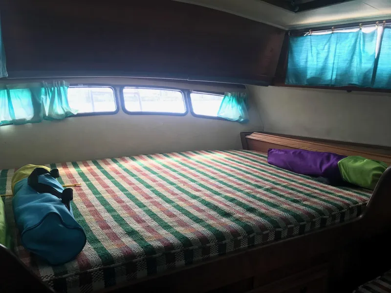 Slide: The Image of Cozy cabin interior of 1978 Islander Freeport 41 Ketch with colorful bedding. - 14