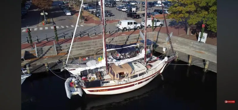 Slide: The Image of 1978 Islander Freeport 41 Ketch docked at a marina, aerial view. - 2