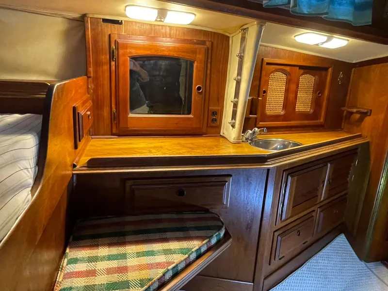 Slide: The Image of 1978 Islander Freeport 41 Ketch interior with wood cabinetry and small sink. - 24