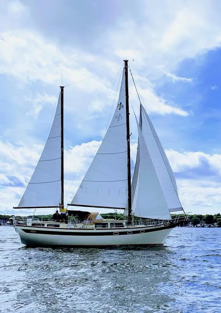Slide: The Image of 1978 Islander Freeport 41 Ketch sailing on a sunny day with full sails. - 3