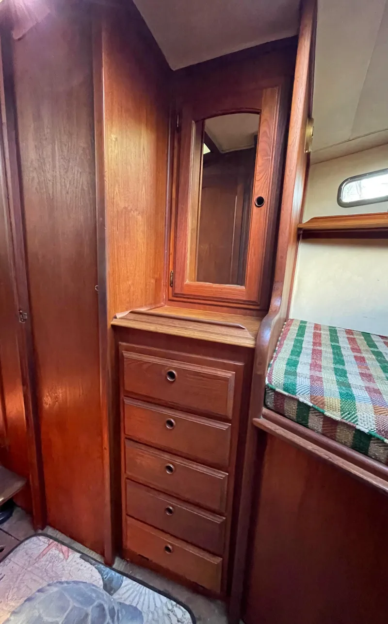 Slide: The Image of 1978 Islander Freeport 41 Ketch interior with wooden drawers and mirror. - 30