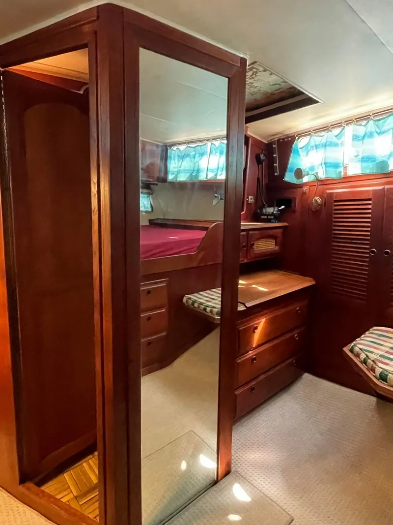 Slide: The Image of Interior of 1978 Islander Freeport 41 Ketch with wood paneling and cozy cabin. - 31