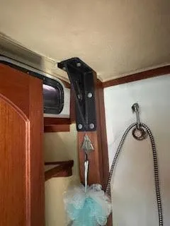 Slide: The Image of Interior of 1978 Islander Freeport 41 Ketch, featuring shower area and wooden trim. - 46