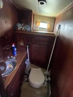 Slide: The Image of 1978 Islander Freeport 41 Ketch bathroom with wooden interior and compact amenities. - 47