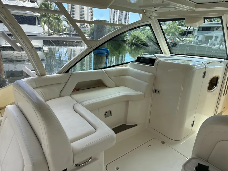Slide: The Image of 2017 Grady-White Freedom 375 boat interior with white seating and waterfront view. - 11