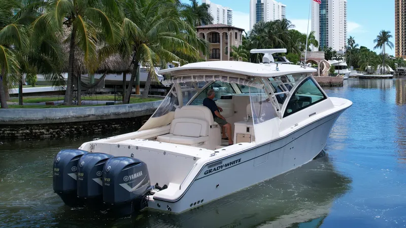 Slide: The Image of 2017 Grady-White Freedom 375 boat cruising in a scenic waterfront setting. - 2