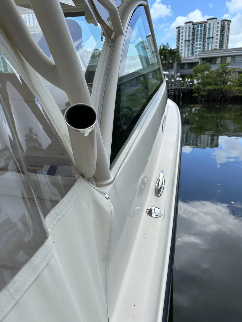 Slide: The Image of 2017 Grady-White Freedom 375 boat docked by water with cityscape background. - 32