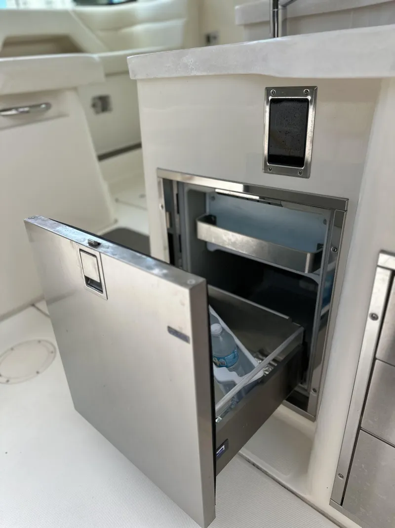 Slide: The Image of 2017 Grady-White Freedom 375 boat with open stainless steel storage compartment. - 48