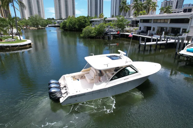 Slide: The Image of 2017 Grady-White Freedom 375 boat cruising in a scenic waterfront area. - 7
