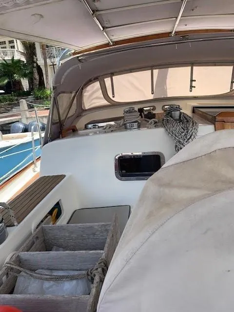 Slide: The Image of 1988 Slocum 43 sailboat cockpit with ropes and winches, docked at marina. - 10