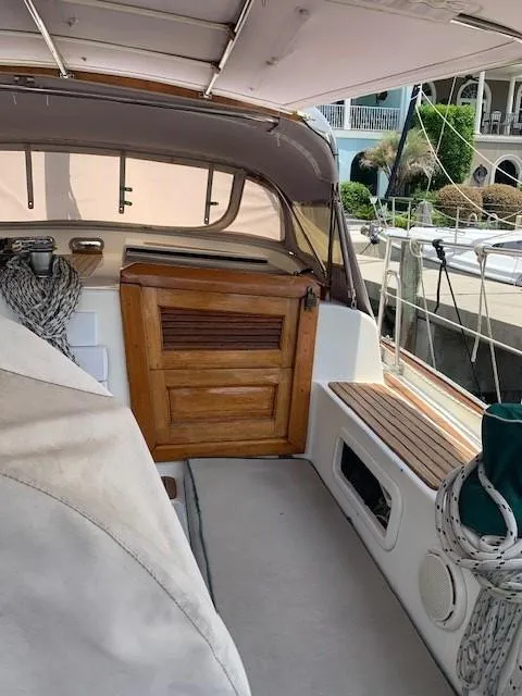 Slide: The Image of 1988 Slocum 43 sailboat cockpit with wooden door and covered seating area. - 11