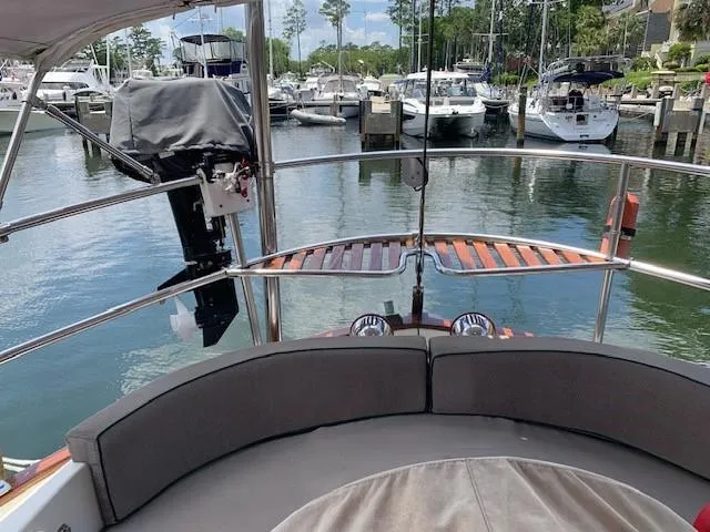 Slide: The Image of Slocum 43 sailboat, 1988 model, docked in a marina with other boats. - 12