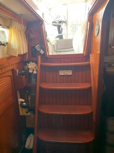 Slide: The Image of Wooden interior stairs of 1988 Slocum 43 sailboat, leading to deck. - 13