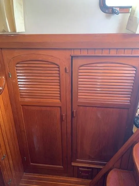 Slide: The Image of Wooden interior of 1988 Slocum 43 sailboat with louvered cabinet doors. - 14