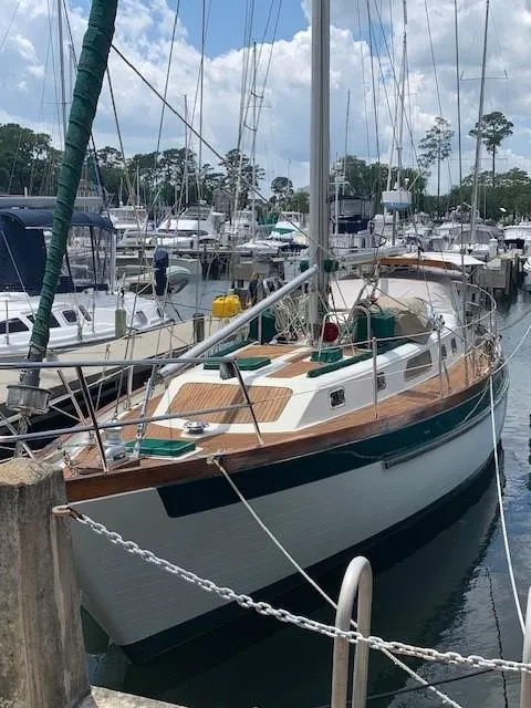 Slide: The Image of 1988 Slocum 43 sailboat docked at a marina, surrounded by other boats. - 3