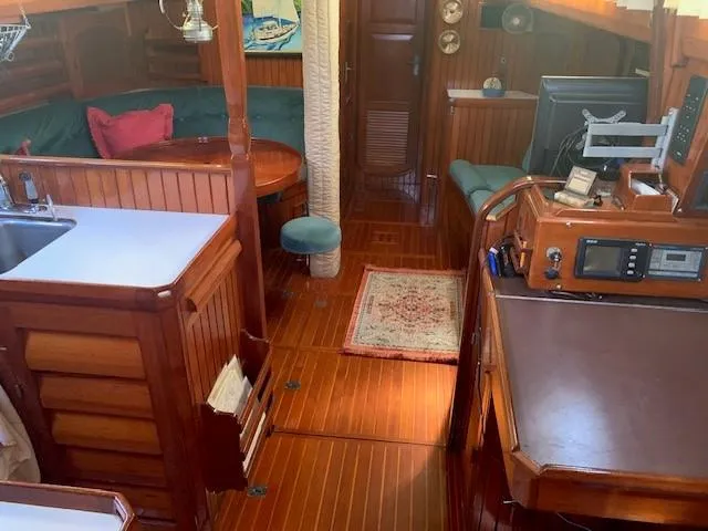 Slide: The Image of Interior of 1988 Slocum 43 sailboat with wooden furnishings and cozy seating area. - 31