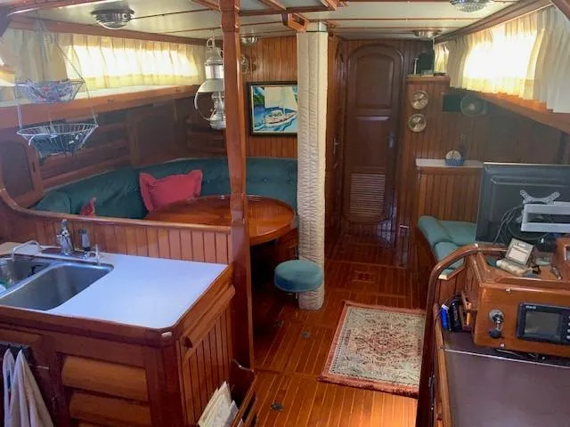 Slide: The Image of Interior of 1988 Slocum 43 sailboat with cozy seating, wooden finishes, and nautical decor. - 33