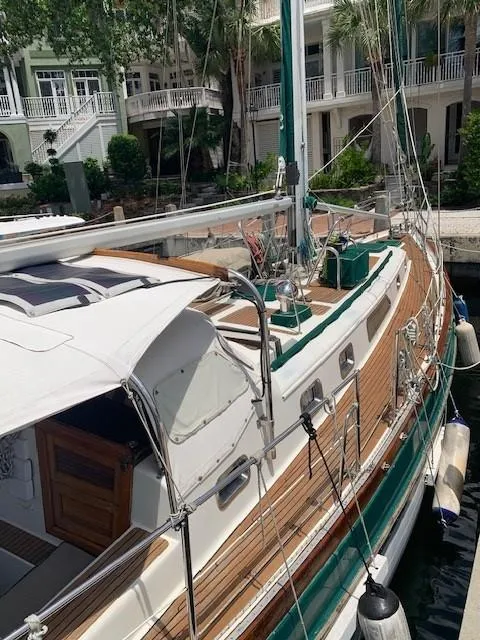 Slide: The Image of 1988 Slocum 43 sailboat docked near elegant waterfront homes. - 5