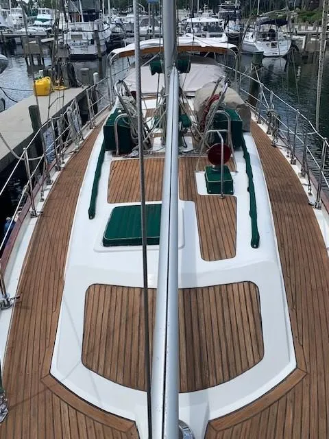 Slide: The Image of 1988 Slocum 43 sailboat with teak deck, docked at a marina. - 6