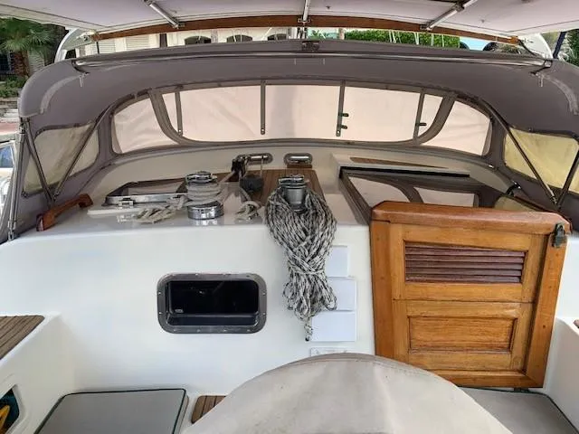 Slide: The Image of 1988 Slocum 43 sailboat cockpit with ropes and wooden hatch. - 9