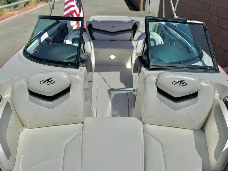 Slide: The Image of 2013 Monterey 214 SS boat interior with American flag, featuring sleek seating and windshield. - 11