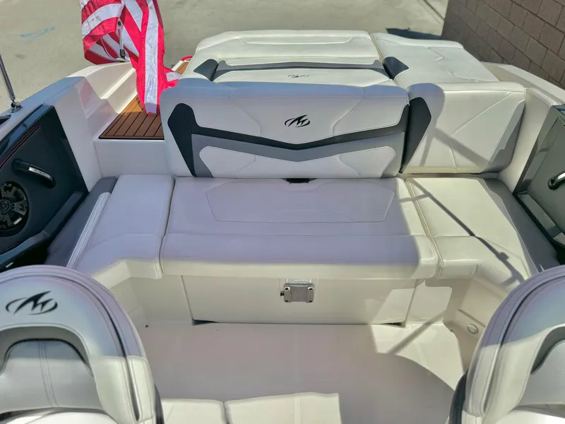 Slide: The Image of 2013 Monterey 214 SS boat interior with white seating and American flag. - 18