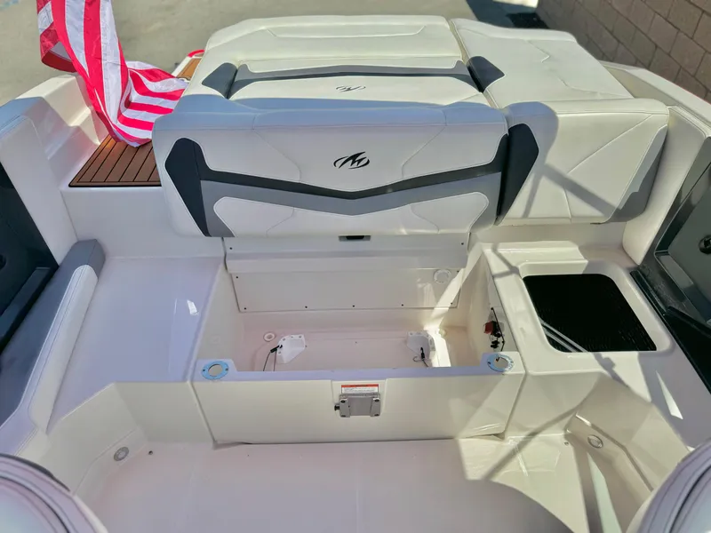Slide: The Image of 2013 Monterey 214 SS boat interior with open storage compartment and seating. - 19