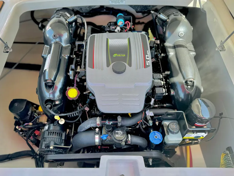 Slide: The Image of 2013 Monterey 214 SS engine compartment, showcasing a powerful marine engine. - 21