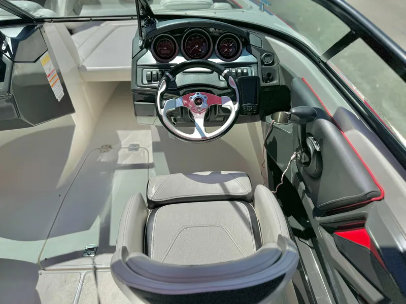 Slide: The Image of 2013 Monterey 214 SS boat interior with steering wheel and dashboard controls. - 23
