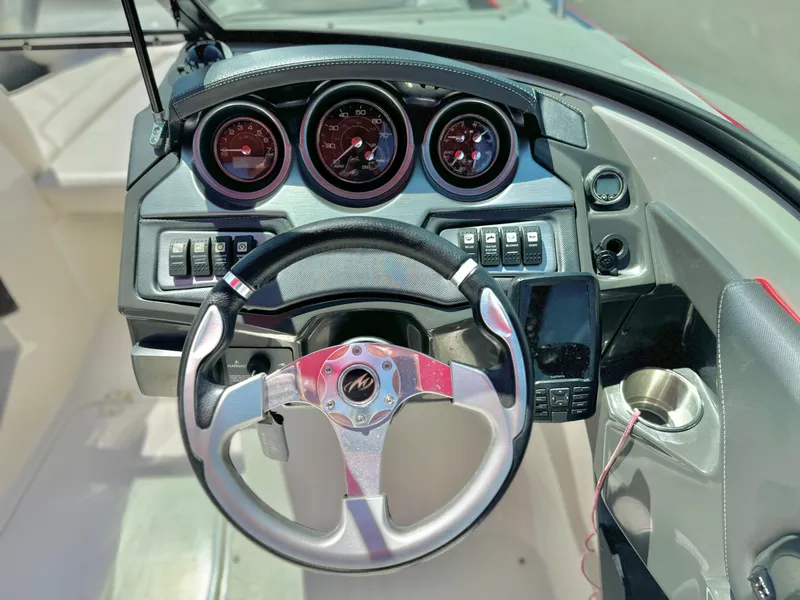 Slide: The Image of 2013 Monterey 214 SS boat dashboard with steering wheel and gauges. - 24