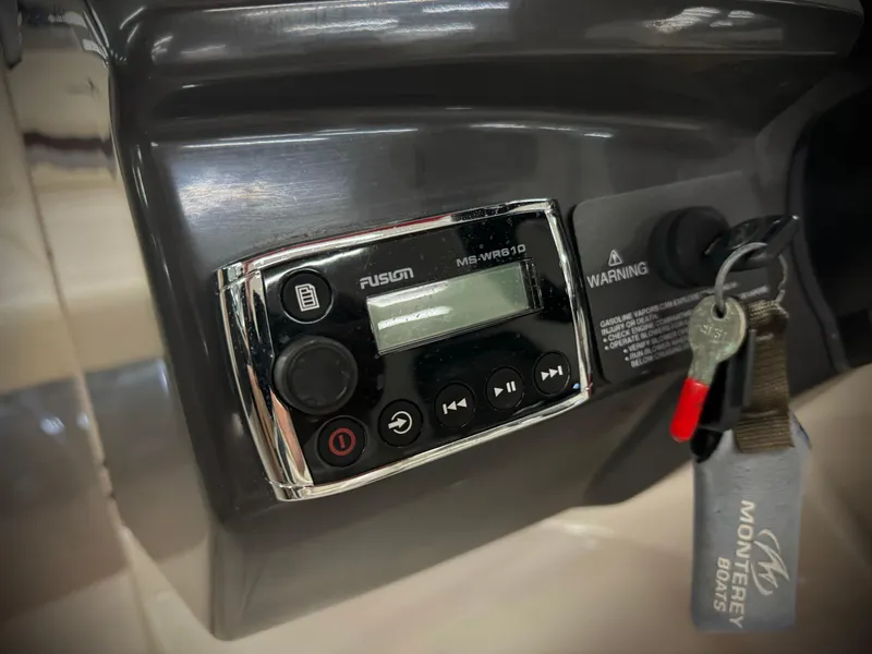 Slide: The Image of Fusion stereo system on 2013 Monterey 214 SS boat dashboard with keys. - 26