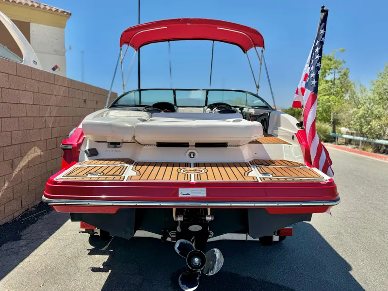 Slide: The Image of 2013 Monterey 214 SS boat with American flag, red canopy, and teak deck. - 4