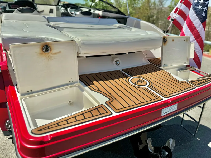 Slide: The Image of 2013 Monterey 214 SS boat with open storage compartments and American flag. - 7