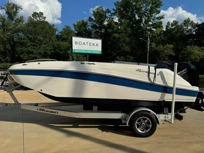 The Image of 2022 Hurricane SS 192RL boat on trailer, certified pre-owned, displayed outdoors. - 1