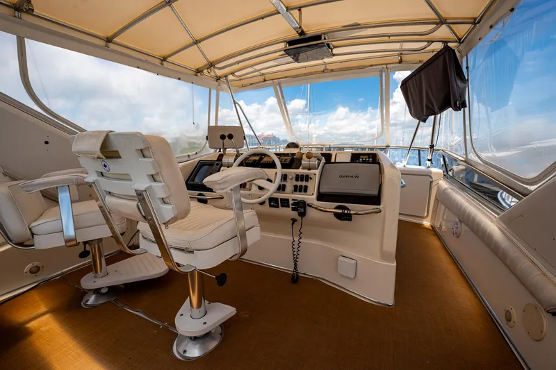Slide: The Image of Interior of 1995 Sea Ray 550 Sedan Bridge yacht with helm and seating. - 14
