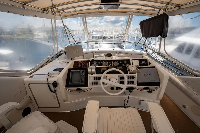Slide: The Image of Interior view of 1995 Sea Ray 550 Sedan Bridge helm with navigation equipment. - 15