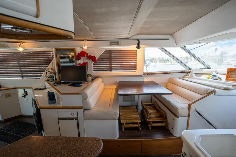 Slide: The Image of Interior of 1995 Sea Ray 550 Sedan Bridge with cozy seating and dining area. - 24