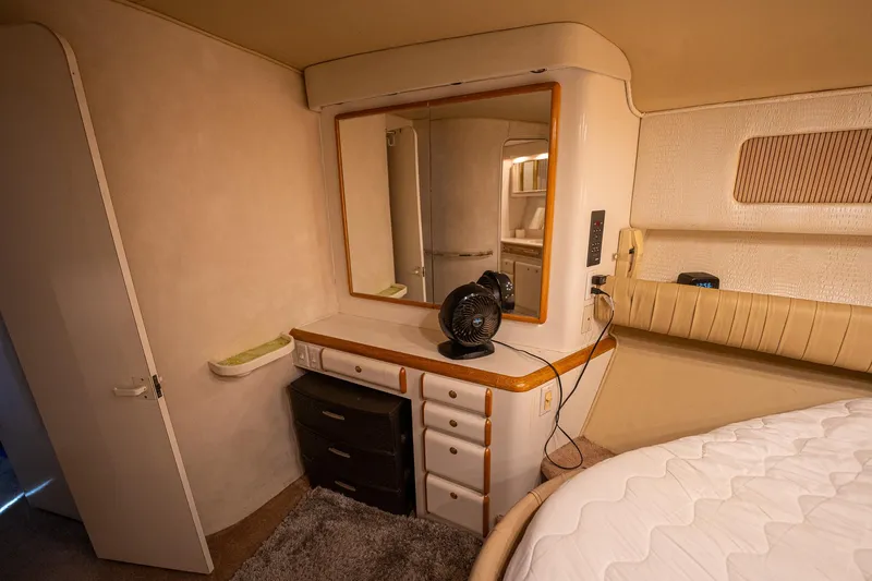 Slide: The Image of Interior cabin of 1995 Sea Ray 550 Sedan Bridge with vanity and storage. - 28