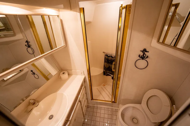 Slide: The Image of Luxurious bathroom in 1995 Sea Ray 550 Sedan Bridge yacht with gold accents. - 30