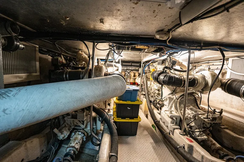Slide: The Image of Engine room of 1995 Sea Ray 550 Sedan Bridge with visible machinery and storage. - 31