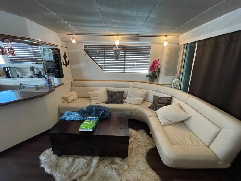 Slide: The Image of Luxurious interior of 1995 Sea Ray 550 Sedan Bridge yacht with plush seating. - 36