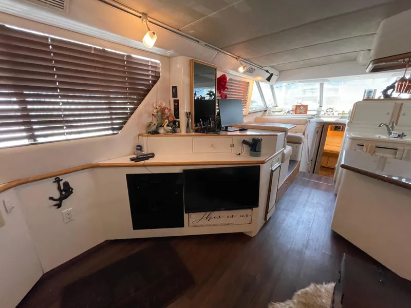 Slide: The Image of Interior of 1995 Sea Ray 550 Sedan Bridge yacht with modern amenities and wood flooring. - 37