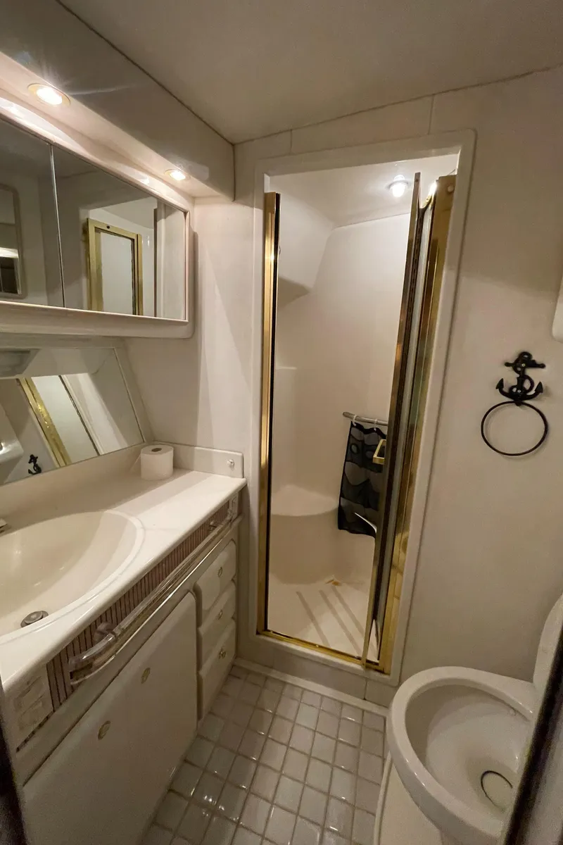 Slide: The Image of Bathroom interior of 1995 Sea Ray 550 Sedan Bridge yacht, featuring shower and vanity. - 38