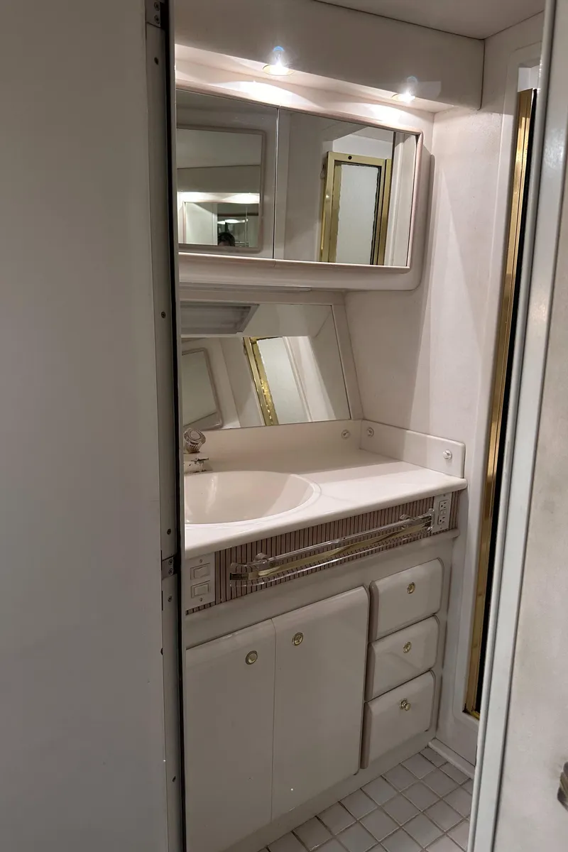 Slide: The Image of Luxurious bathroom in 1995 Sea Ray 550 Sedan Bridge yacht with mirrored cabinets. - 42