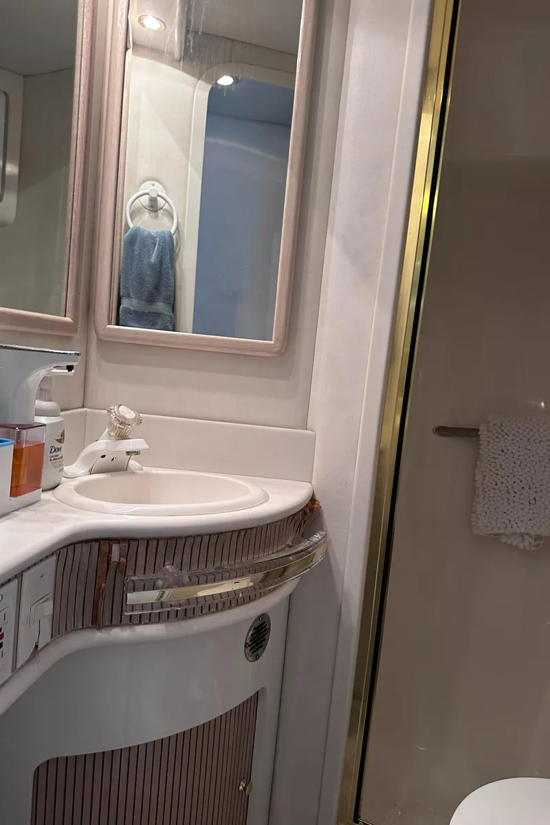 Slide: The Image of Bathroom interior of 1995 Sea Ray 550 Sedan Bridge yacht, featuring sink and mirror. - 43