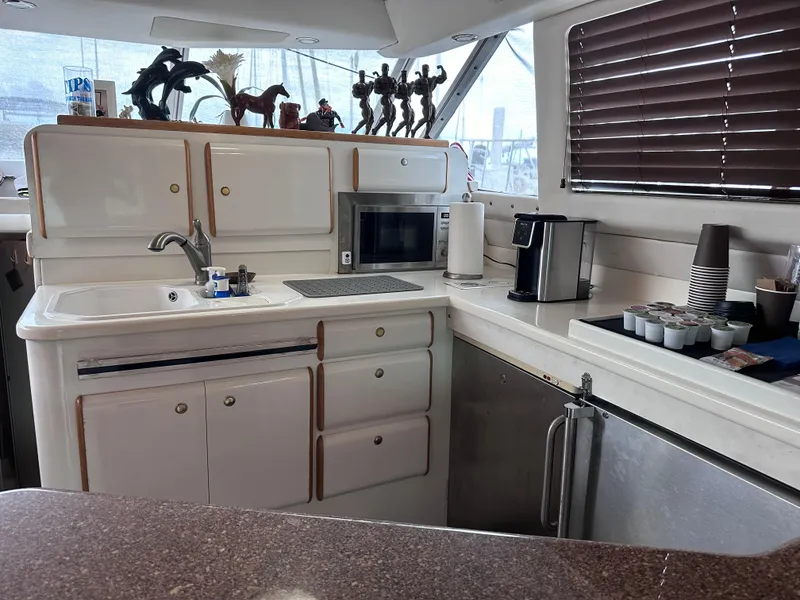 Slide: The Image of Interior kitchen of 1995 Sea Ray 550 Sedan Bridge yacht with modern appliances. - 46